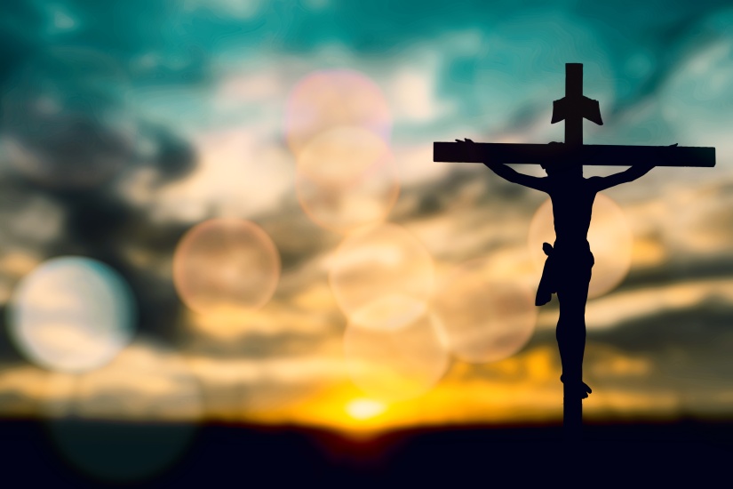 Silhouette of Jesus with Cross over sunset concept for religion,